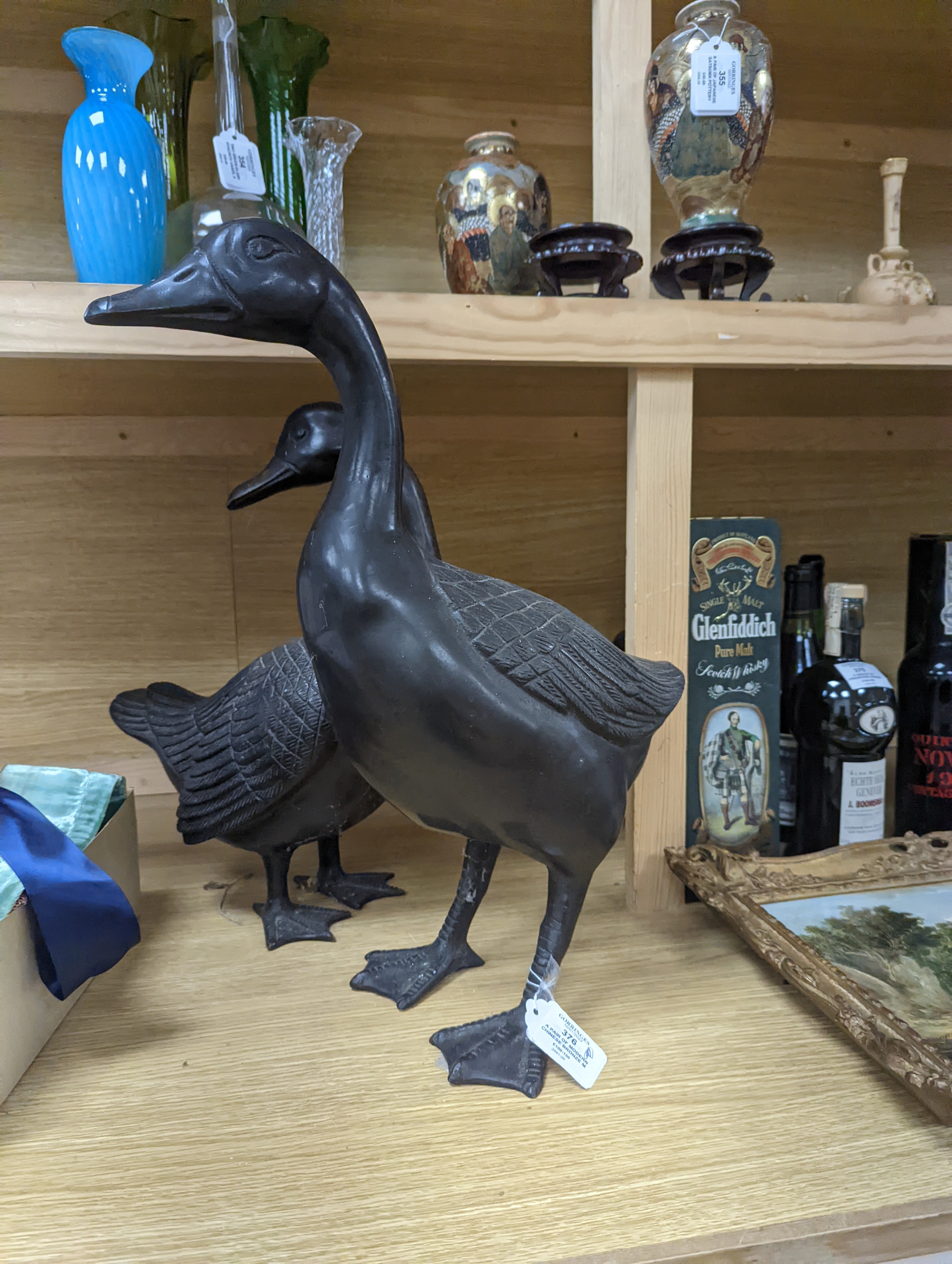 A pair of modern Chinese bronze models of geese, largest 48cm